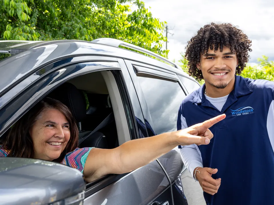 Woodstock Car Wash team member helping a member at the wash entrance