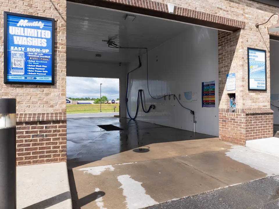 Self-serve wash bay with high pressure wand at Woodstock Car Wash