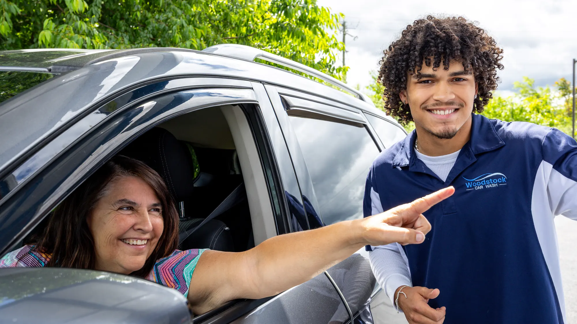 Woodstock Car Wash team member welcoming a customer