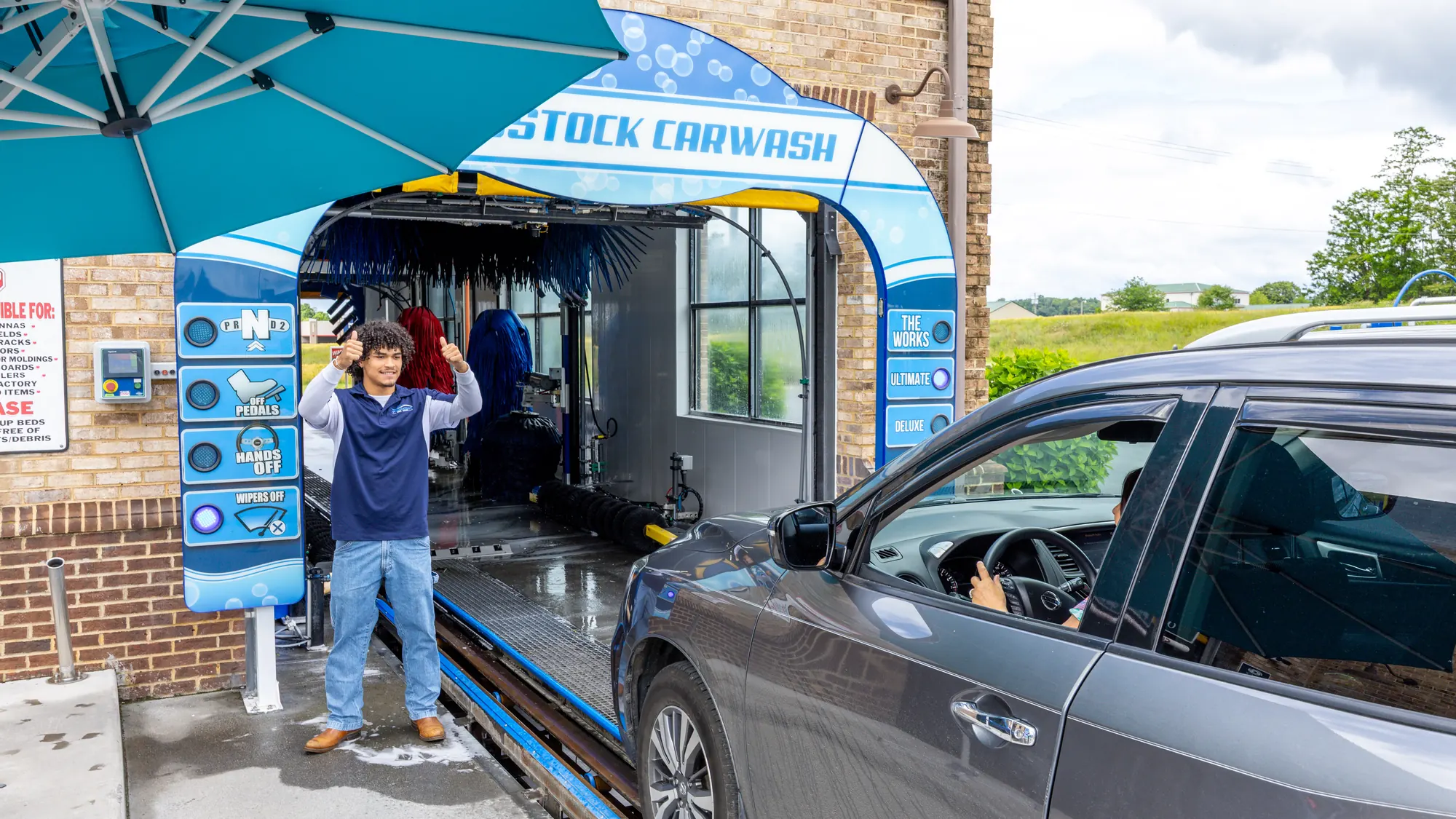 Family at the Woodstock Car Wash pay station in Woodstock, Virginia